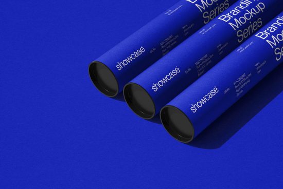 Three cylindrical blue mockup posters with branding displayed on a textured blue background perfect for design presentations.